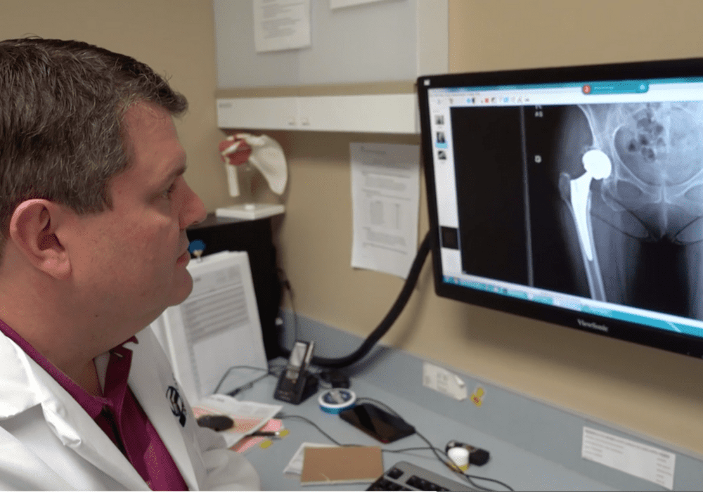 Specialist reviews x-ray for Anterior Approach Total Hip Replacement